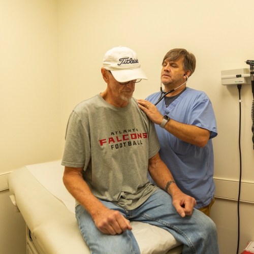 man on medical table going through medical exam