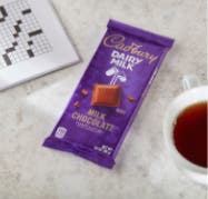 cadbury milk chocolate bar by sudoku puzzle and coffee cup