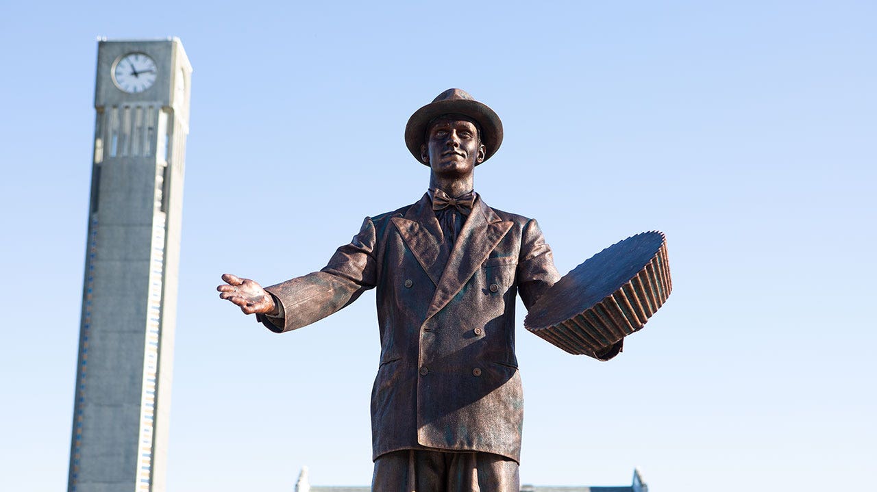 statue of man holding reeses cup