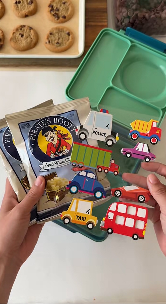 stickers and pirates booty being held above lunchbox