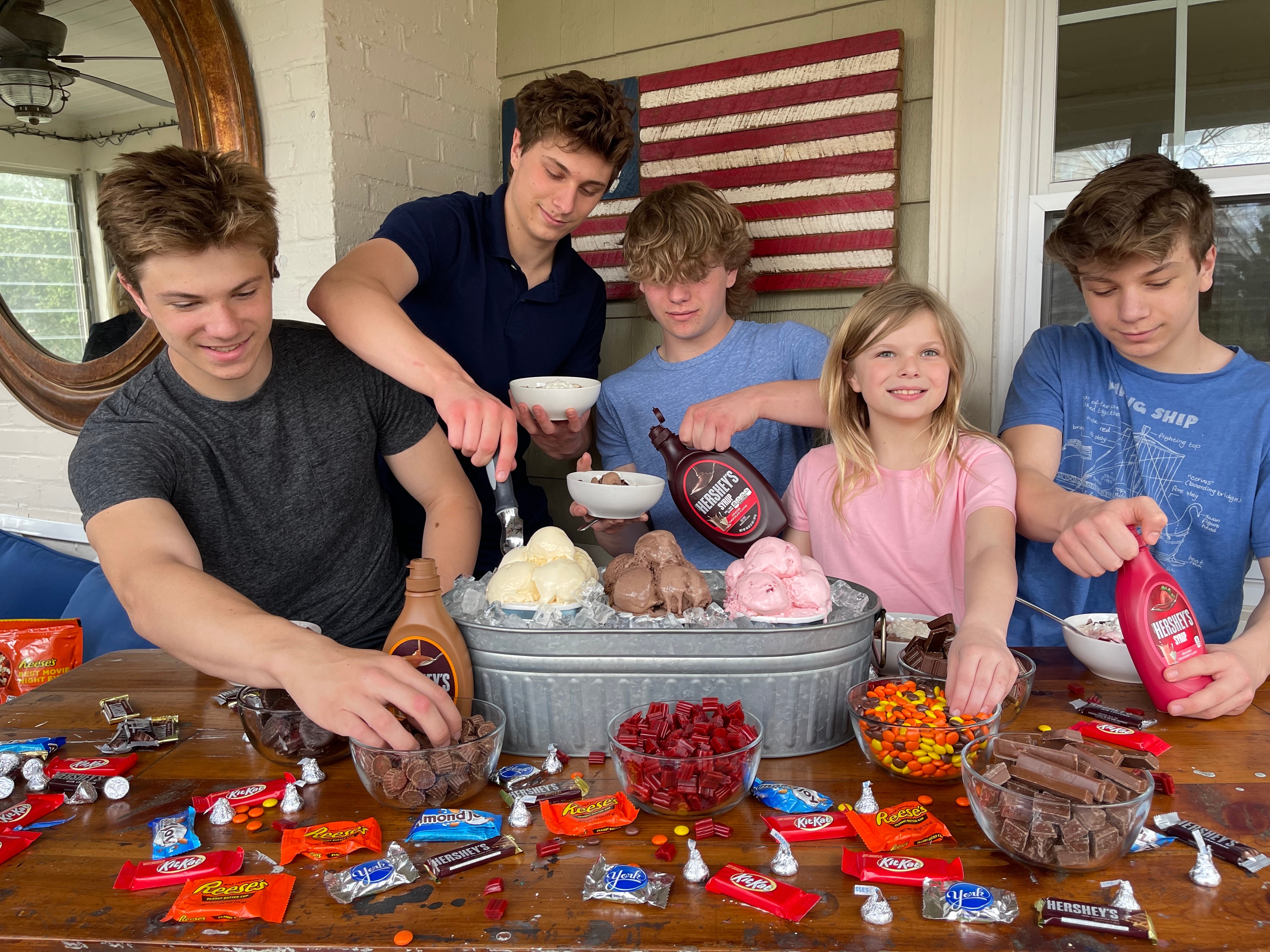 A group of kids building ice cream sundaes 