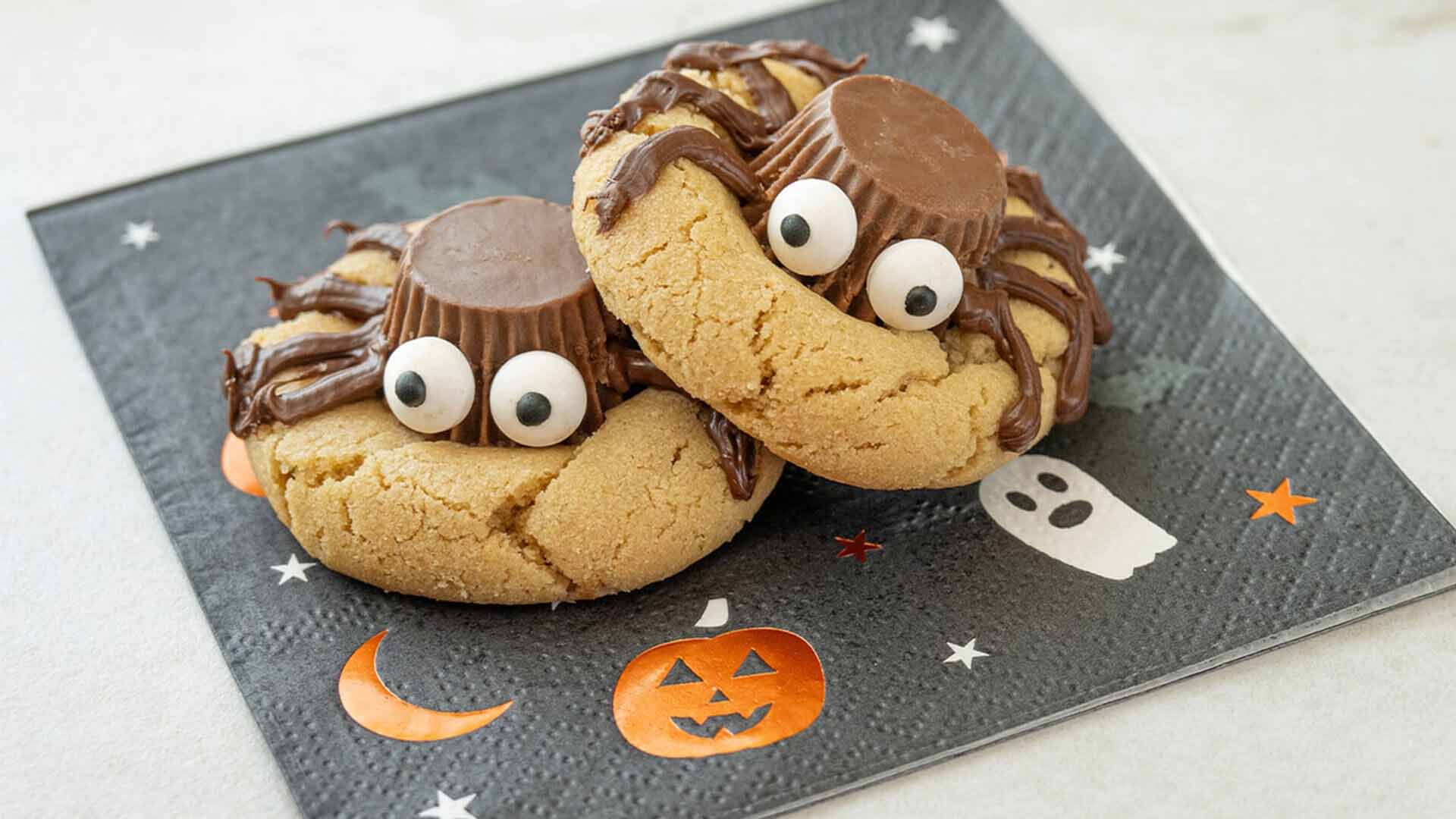 pair of reeses halloween spider cookies on a napkin
