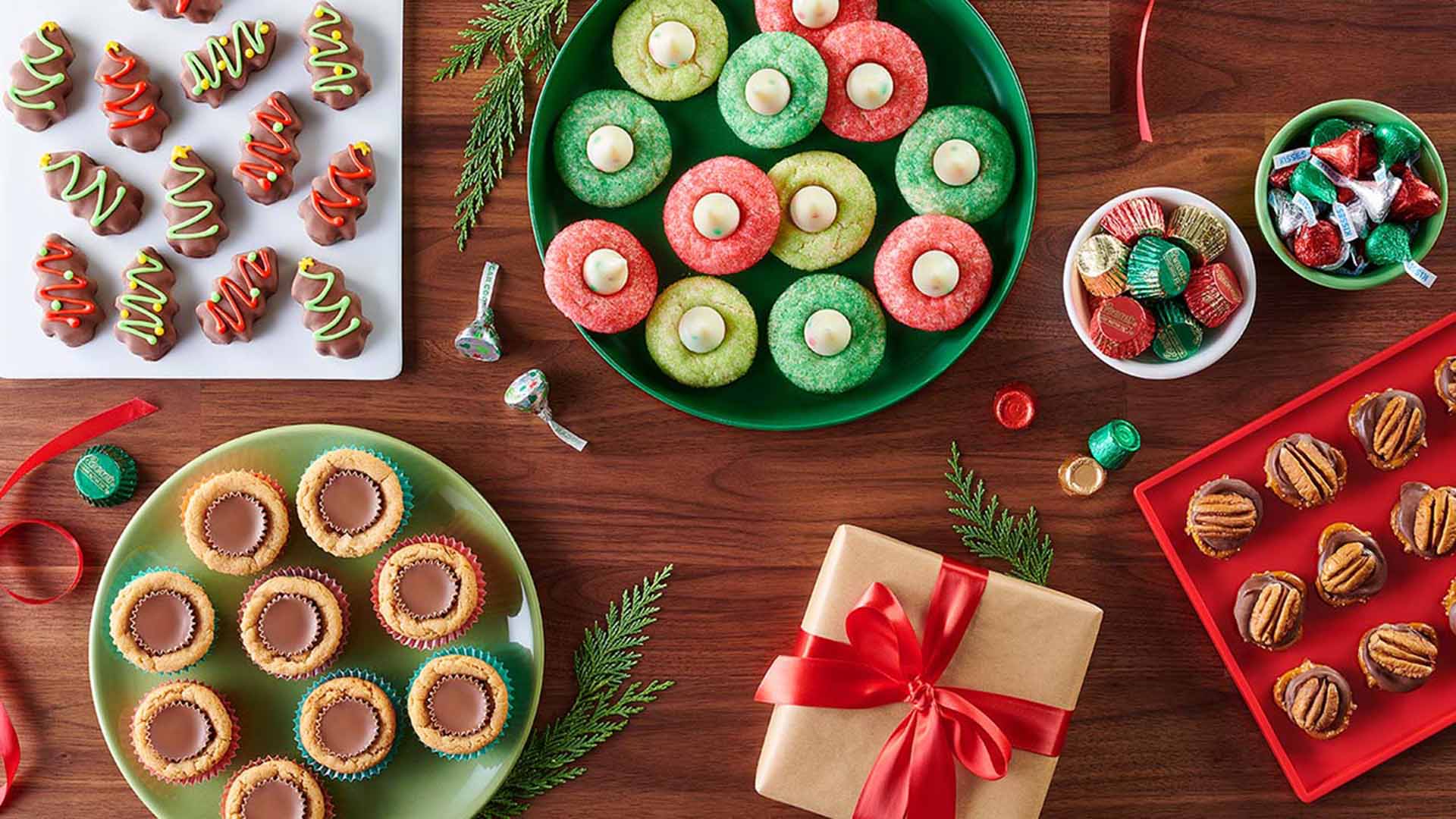 assorted holiday baked goods and bowls full of hersheys candy