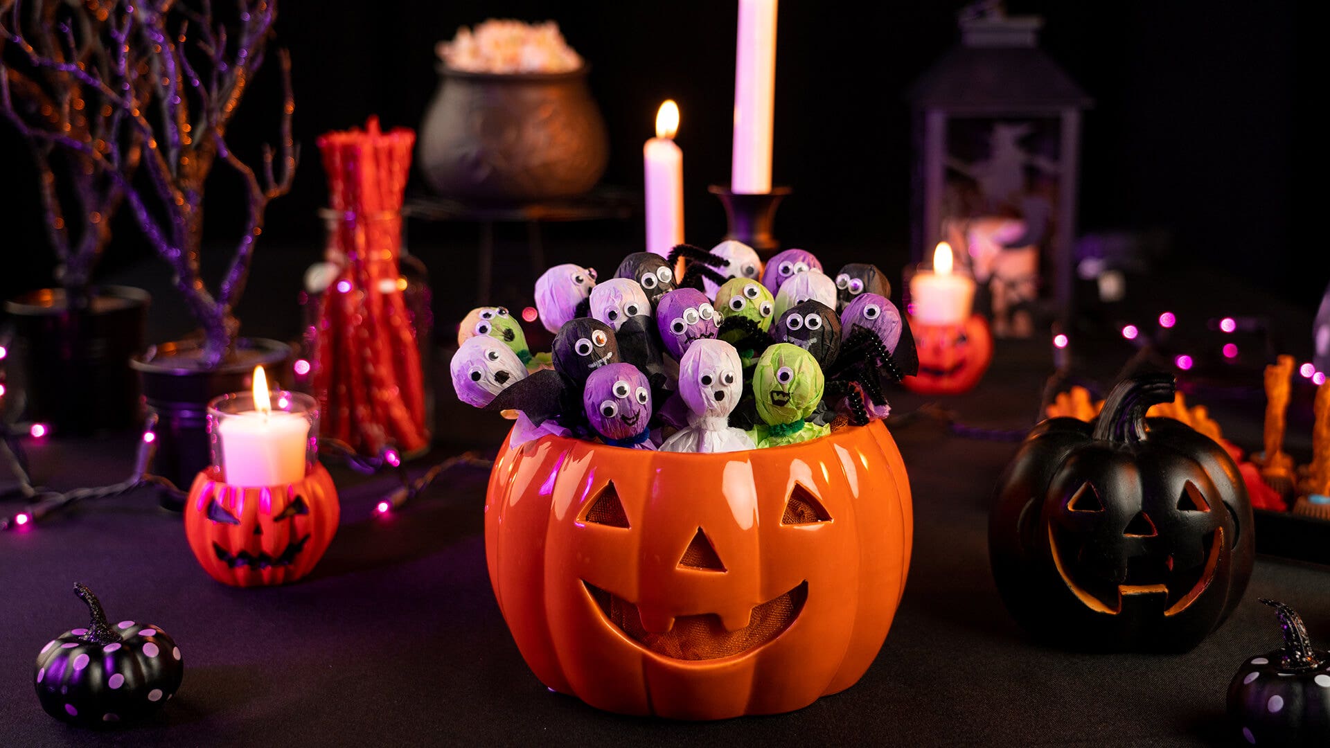 halloween themed monster and ghost lollipop crafts in a pumpkin
