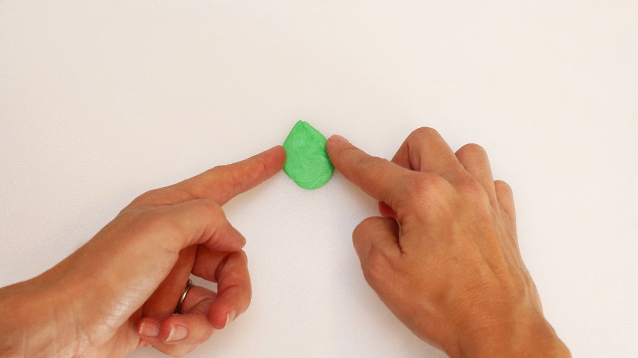 mold green fondant ball into a leaf shape