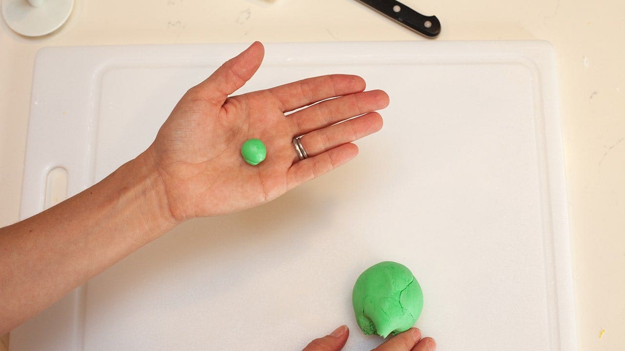 begin rolling green fondant into a ball