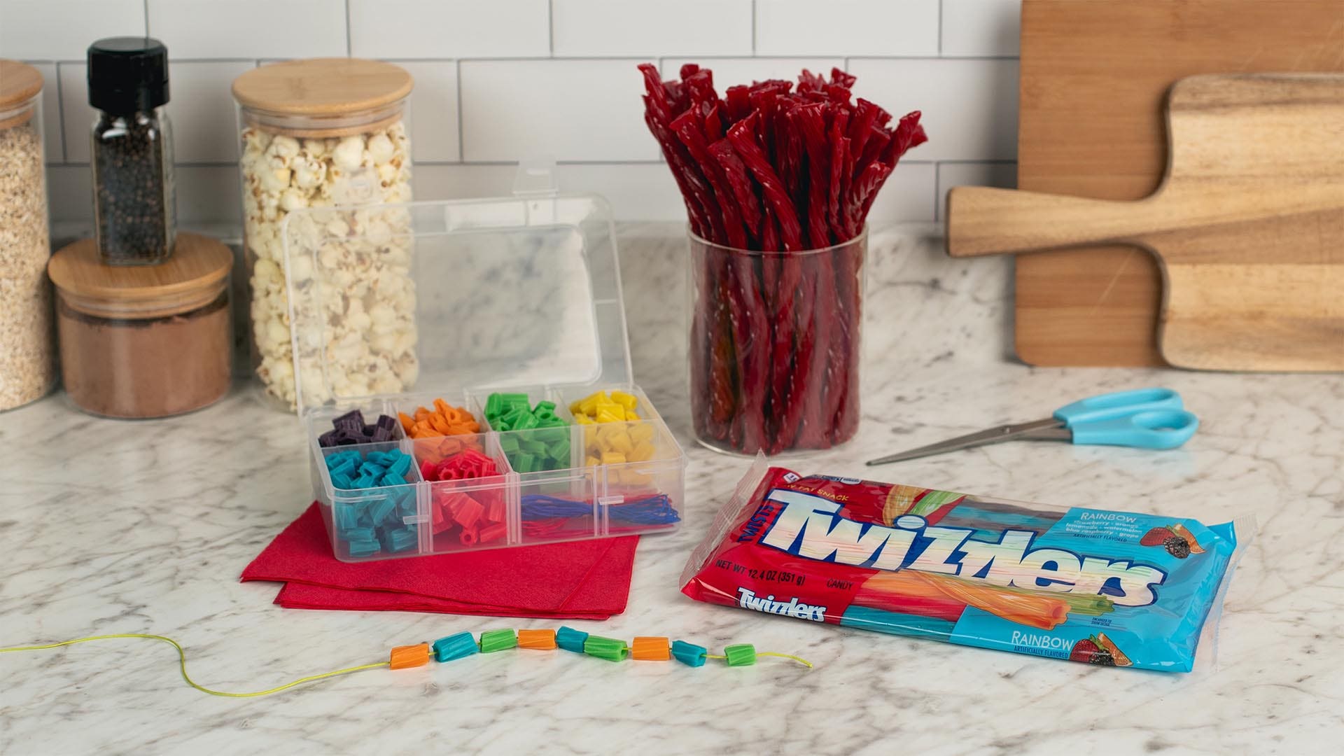clear jewelry box filled with twizzlers rainbow candy cut into small pieces.