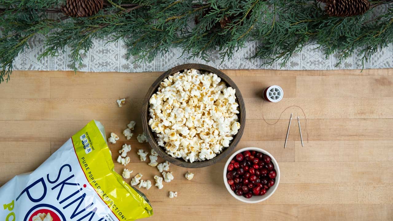 one bowl filled with skinnypop popcorn and the other with cranberries