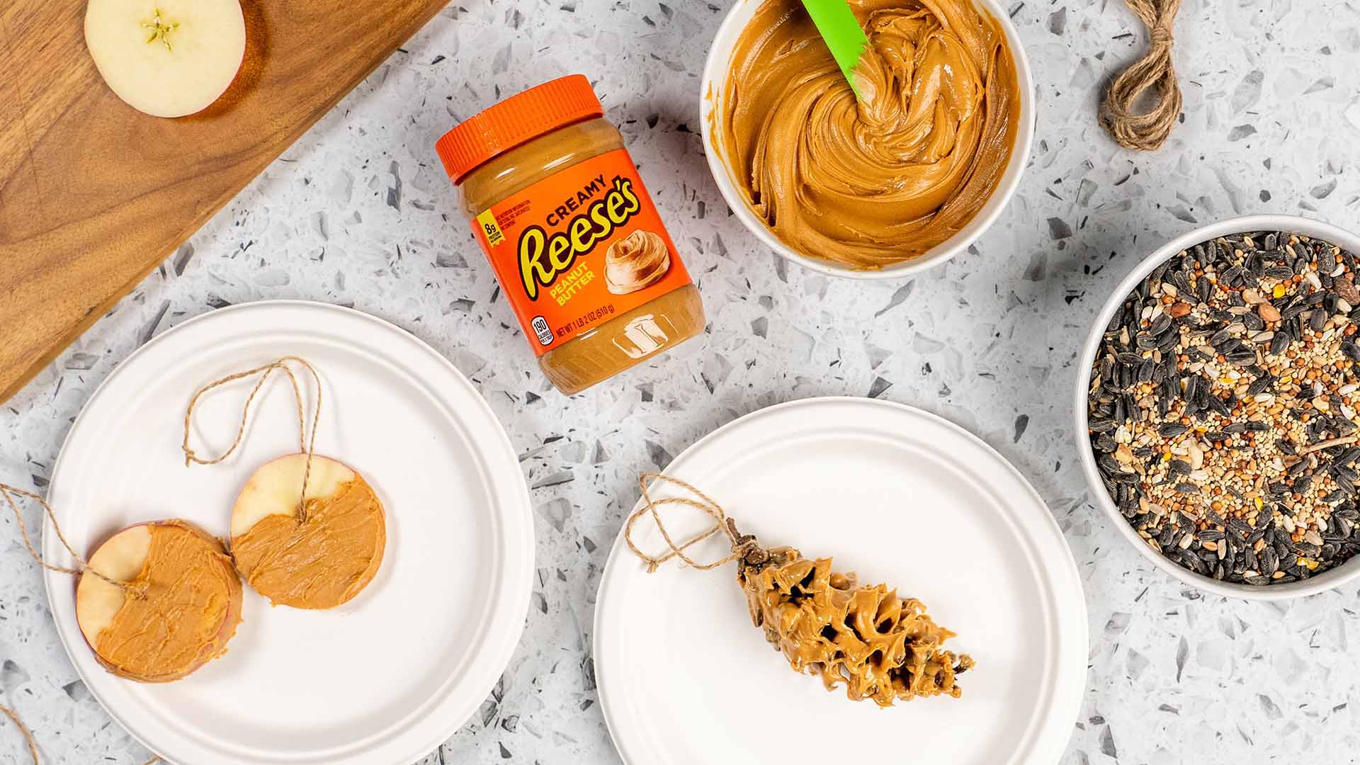 coating the pinecone and apple in reeses peanut butter by rolling