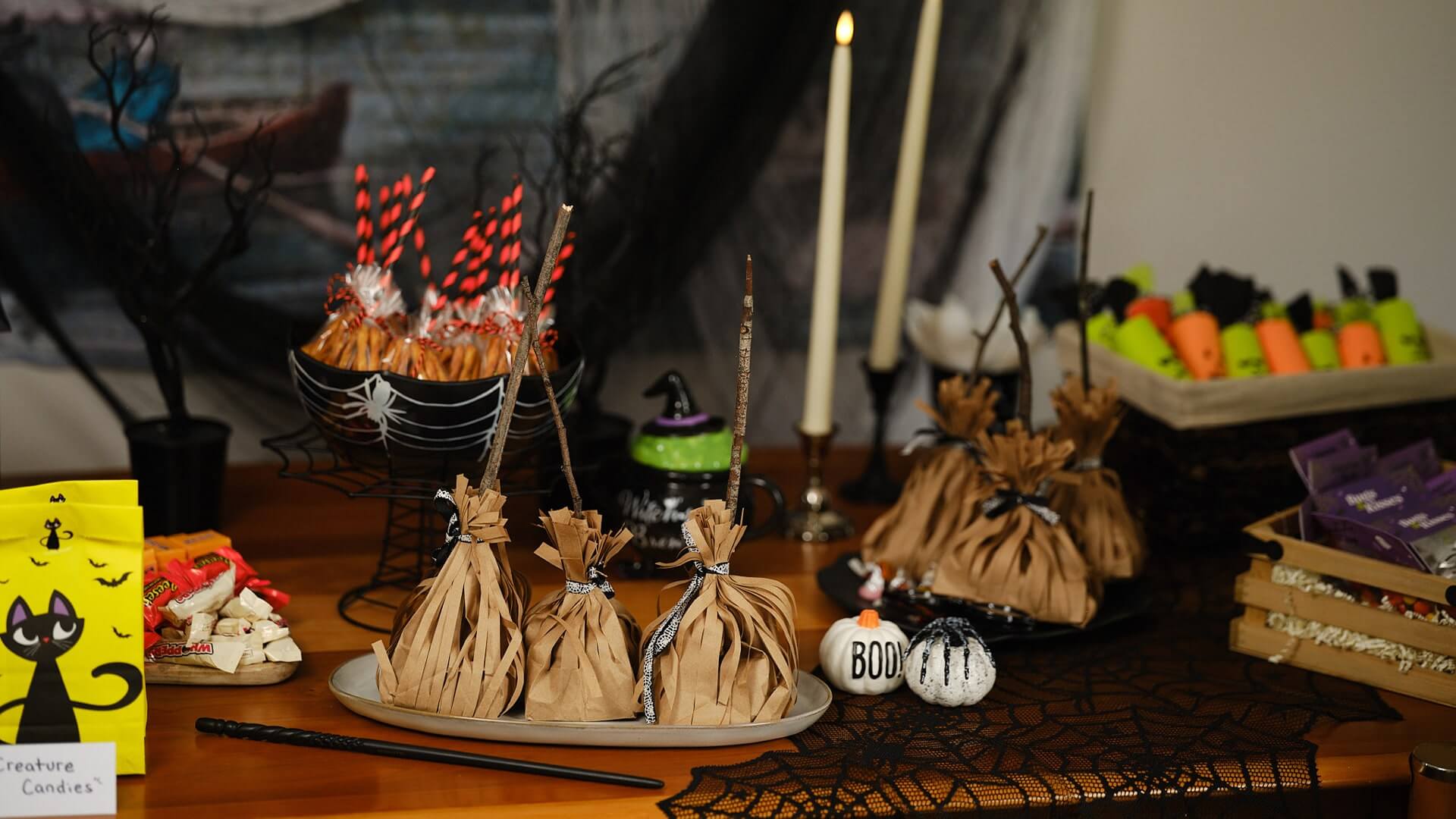 harry potter broomstick themed treat bags on halloween themed table