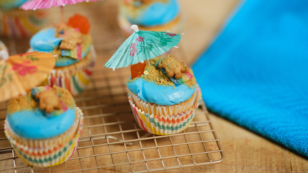 tray of fully decorated beach day cupcakes ready to serve