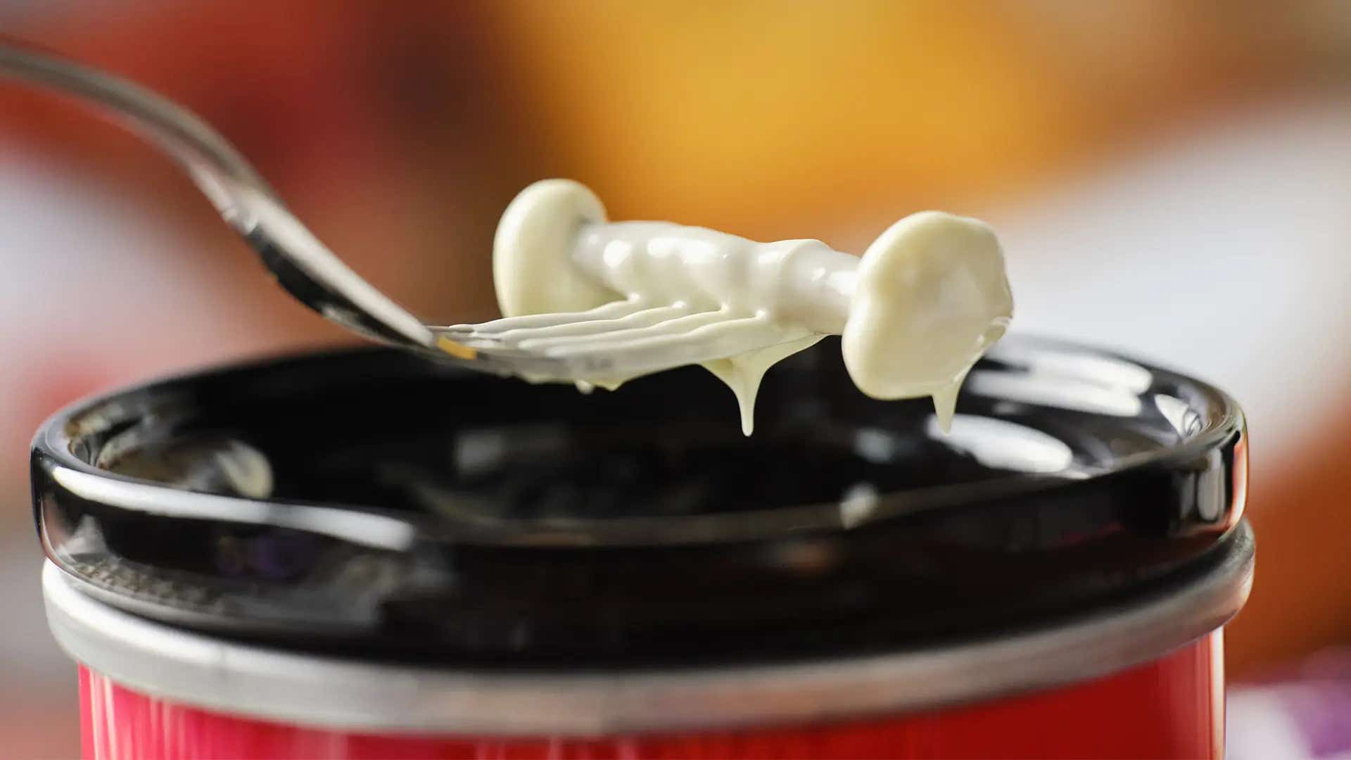dipping pretzel and marshmallows sticks into melted chocolate