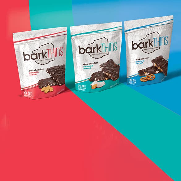 Bark Thins bags over a colored background