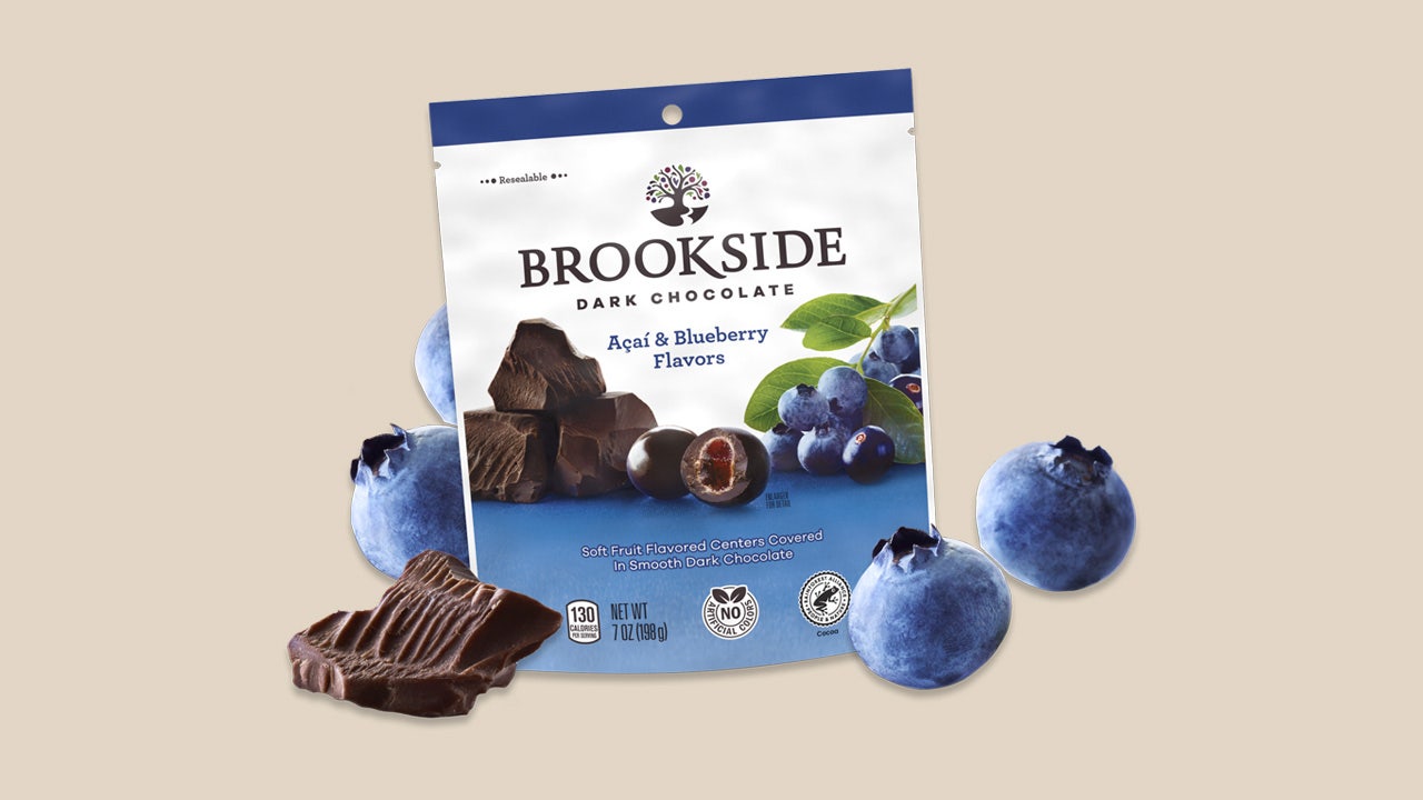 bag of brookside dark chocolate candy beside fresh blueberries and dark chocolate chunks