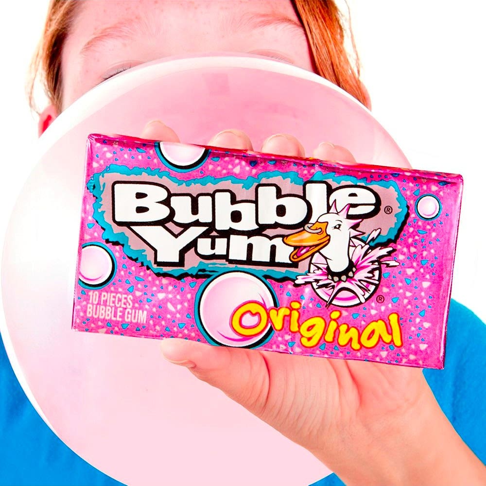 Person holding a pack of Bubble Yum bubble gum