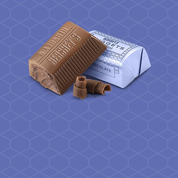 unwrapped milk chocolate nuggets on patterned background