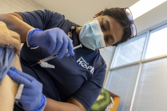 healthcare worker administering a shot