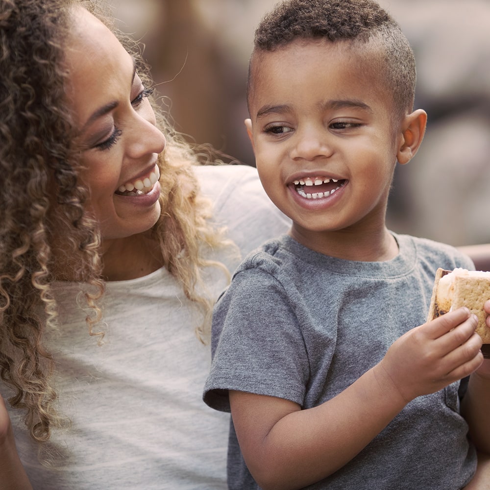 parent and child enjoying a smore