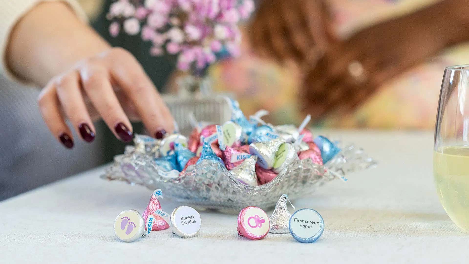 woman reaching for a bowl of hershey kisses conversation foils milk chocolate candy