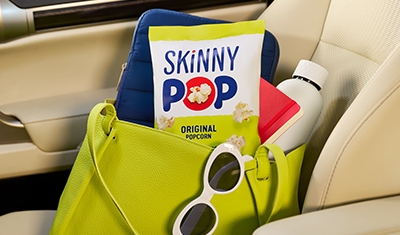 bag of skinny pop in a beach bag