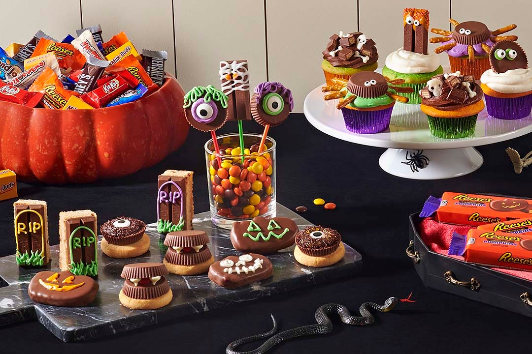 halloween themed table with hersheys candies and treats made with halloween candy