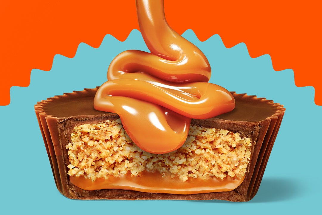 caramel syrup pouring down on an unwrapped reeses peanut butter big cup