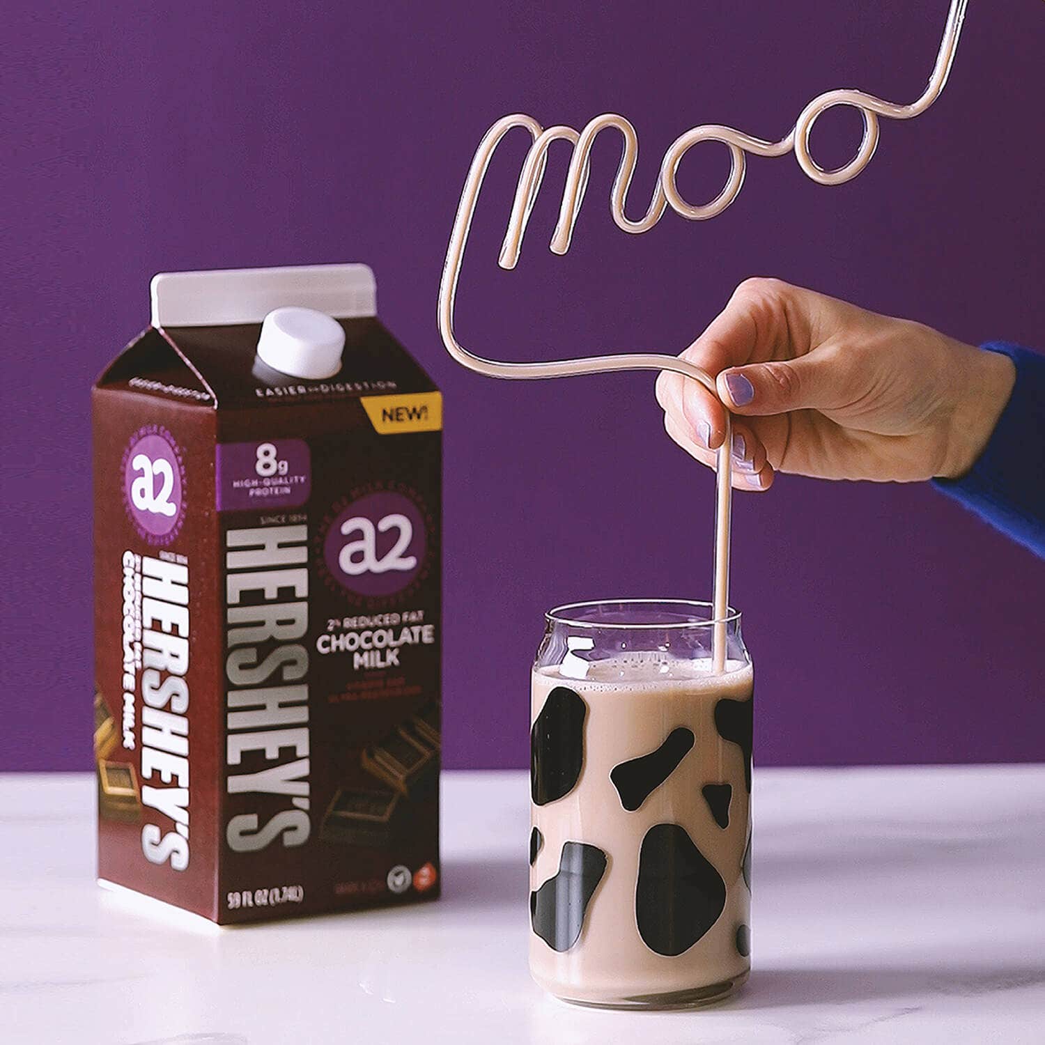 HERSHEY'S a2 Milk Chocolate Milk in cow themed glass with bendy straw