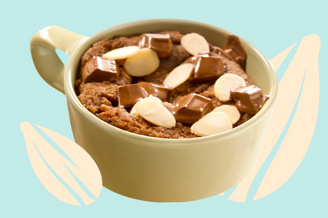 chocolate almond cake in a mug beside illustrations of almonds