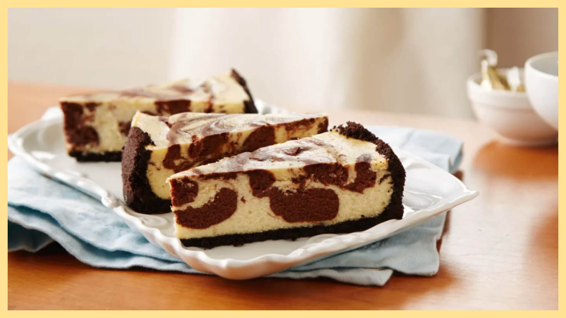 serving plate with three slices of chocolate swirl cheesecake with chocolate crust