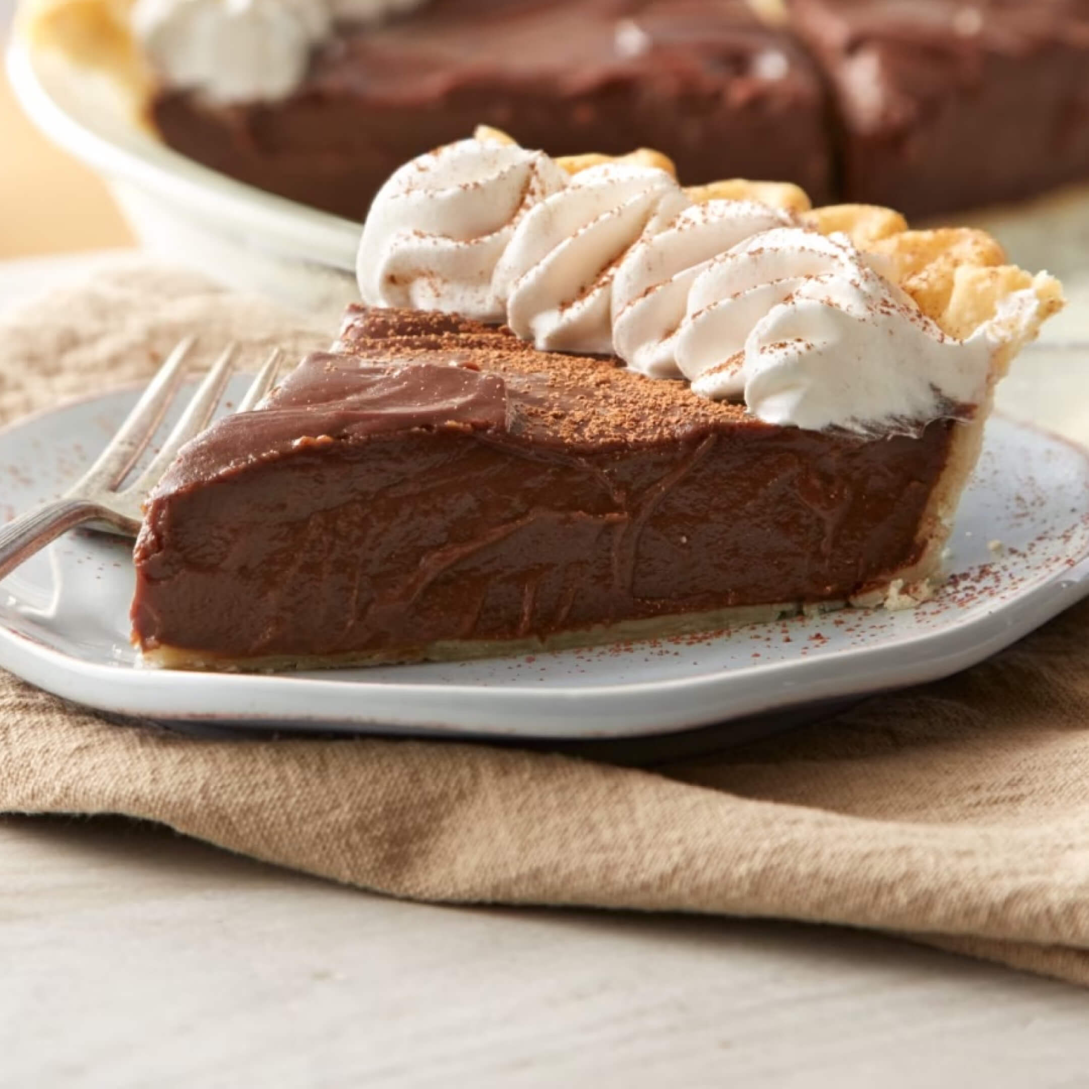 slice of hersheys classic chocolate cream pie topped with whipped cream