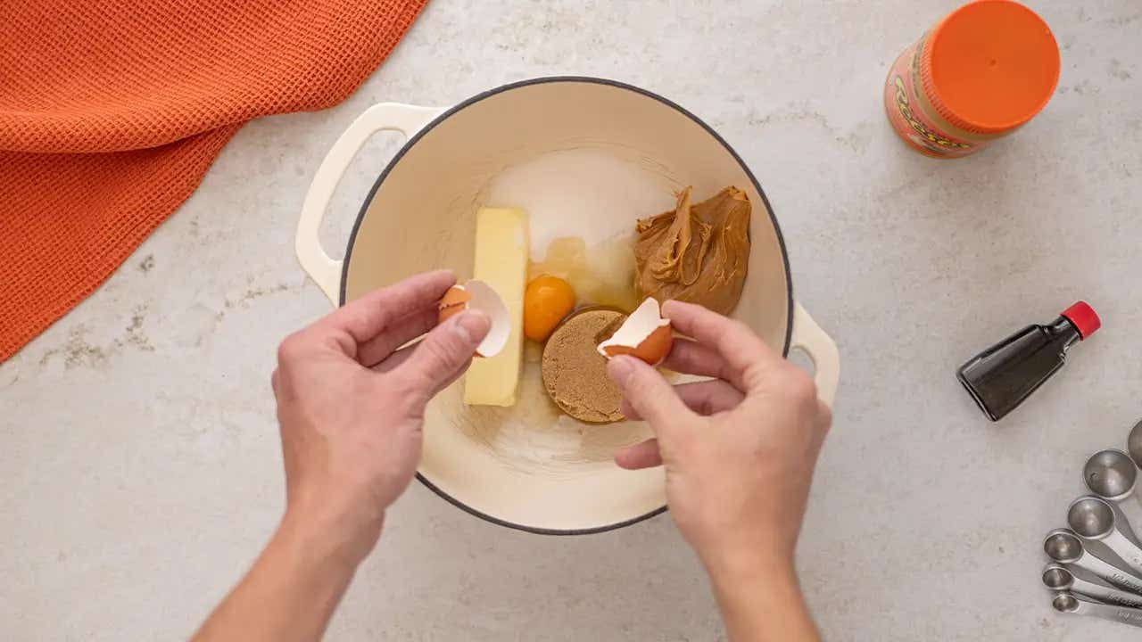 cracking egg into mixing bowl with other ingredients