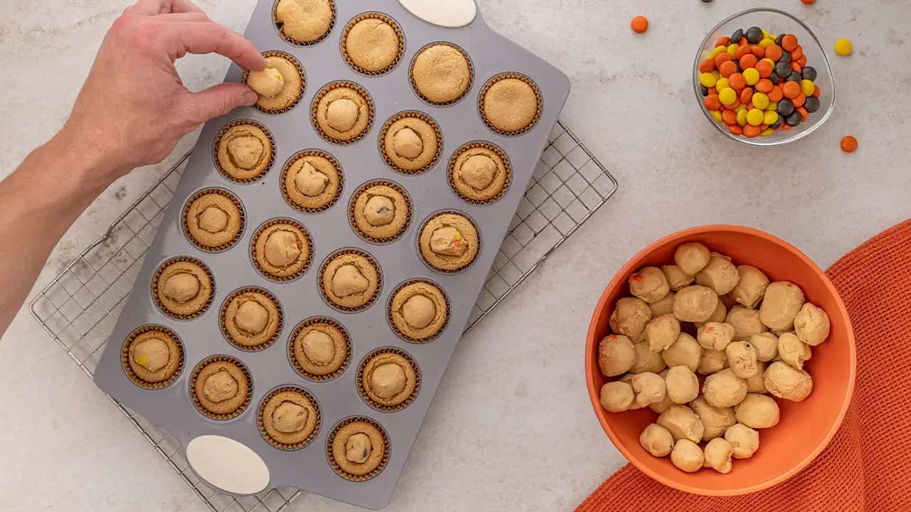 chilled peanut butter ball placed on top of cookies