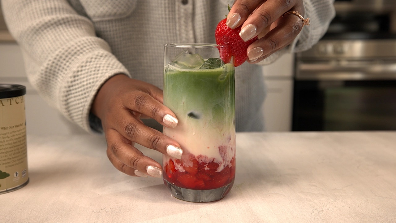 strawberry matcha iced latte in tall glass