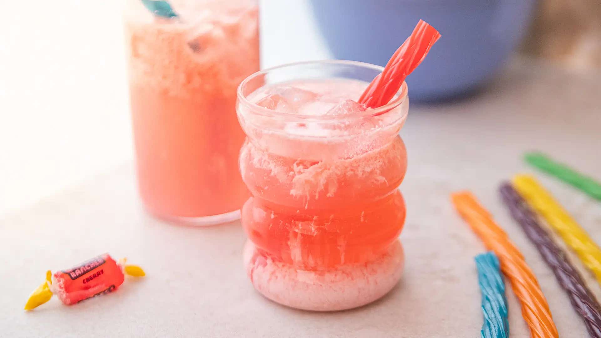 two glasses of cherry vanilla dirty soda with twizzlers rainbow twists and jolly ranchers