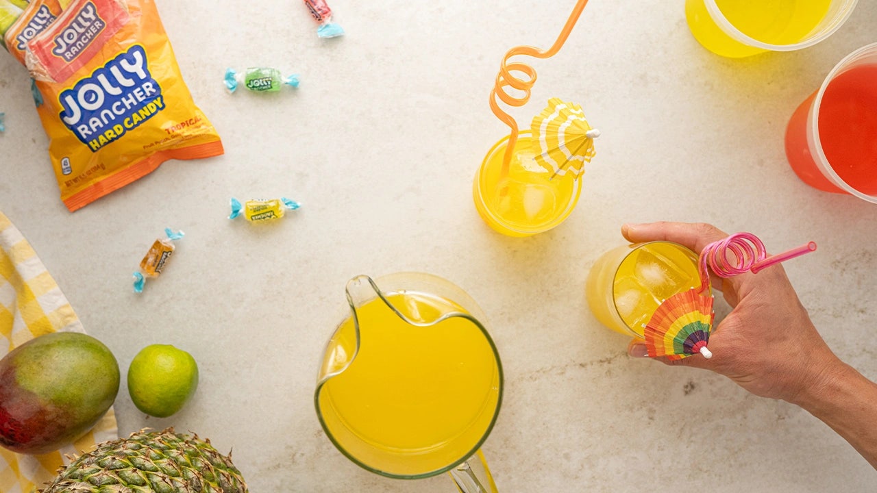 person grabbing a jolly rancher homemade soda
