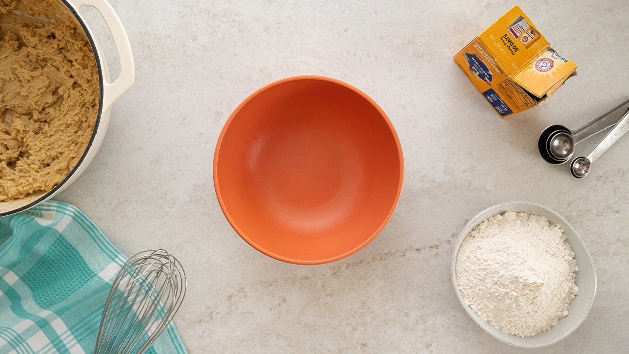 adding flour, baking soda and salt into a separate bowl