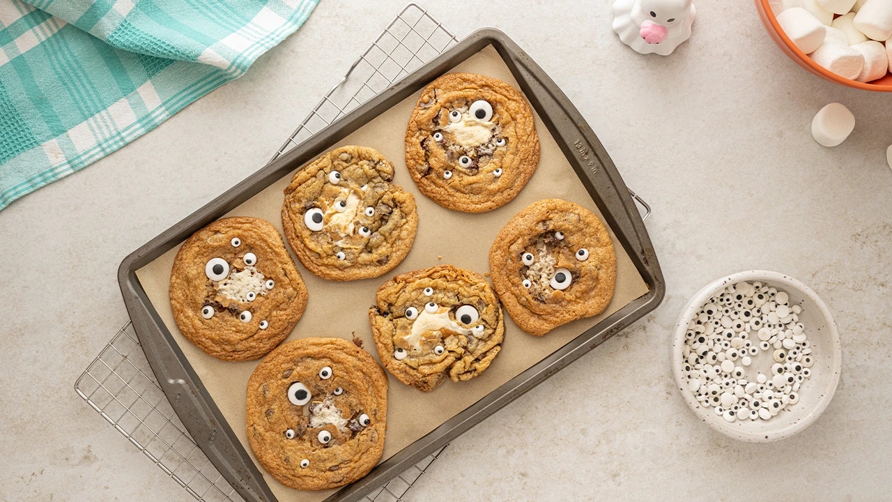 fully baked cookies cooling on top of a baking sheet