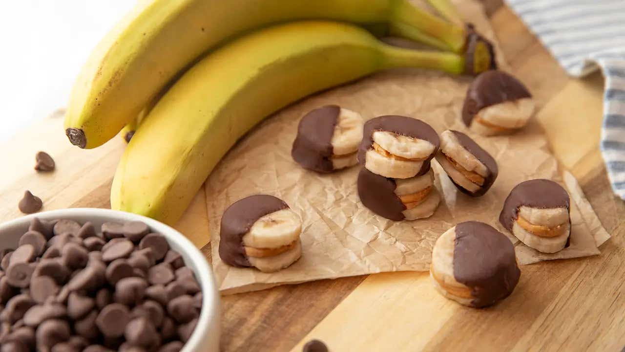 frozen banana bites with bowl of chocolate chips