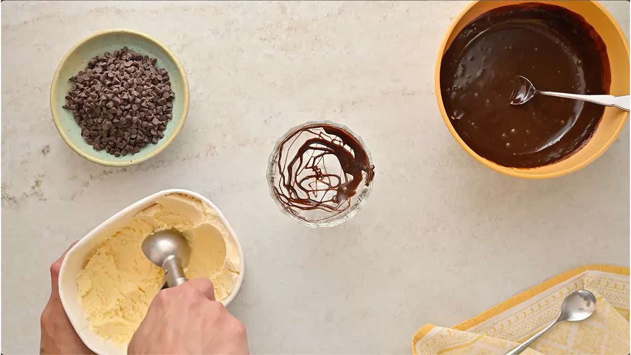 person scooping vanilla ice cream