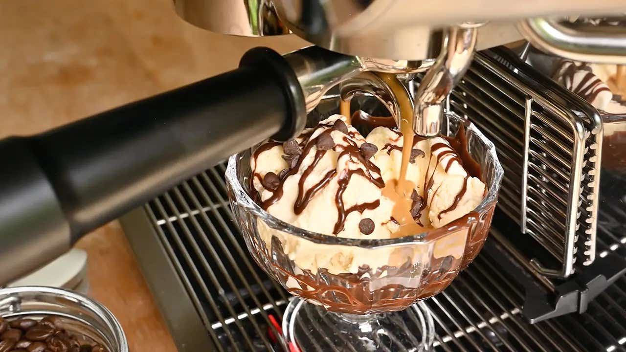 pouring espresso over the ice cream in the glass dessert cup