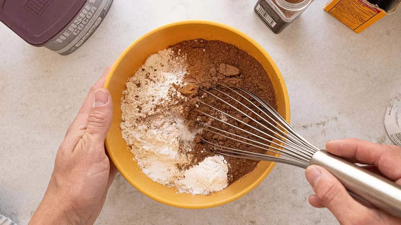flour, cocoa and dry ingredients in mixing bowl with whisk