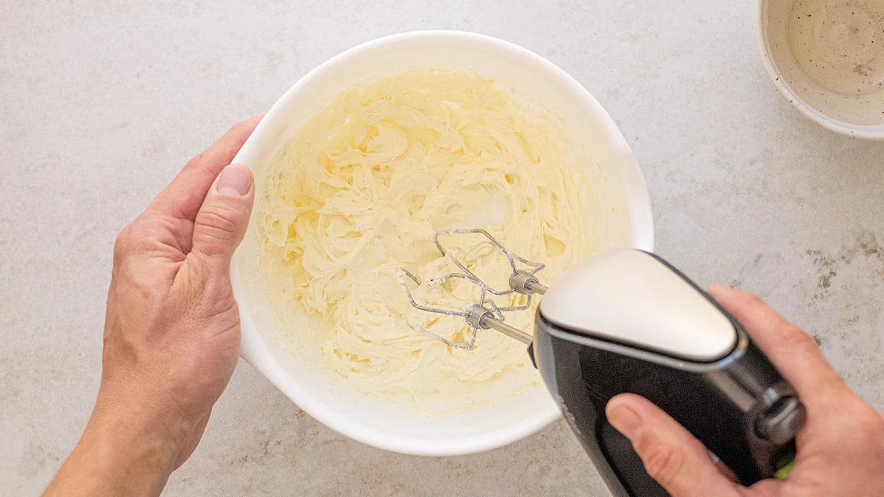 creamed butter and sugar in mixing bowl with hand mixer