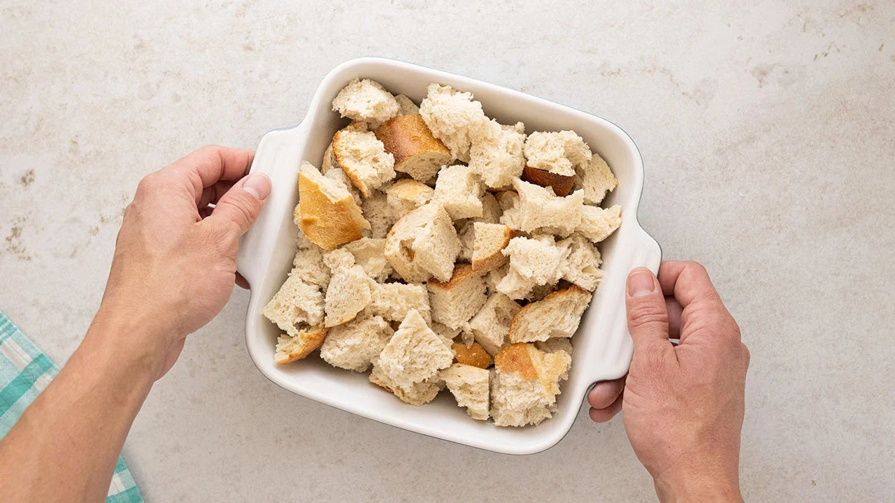 torn french bread pieces in casserole dish