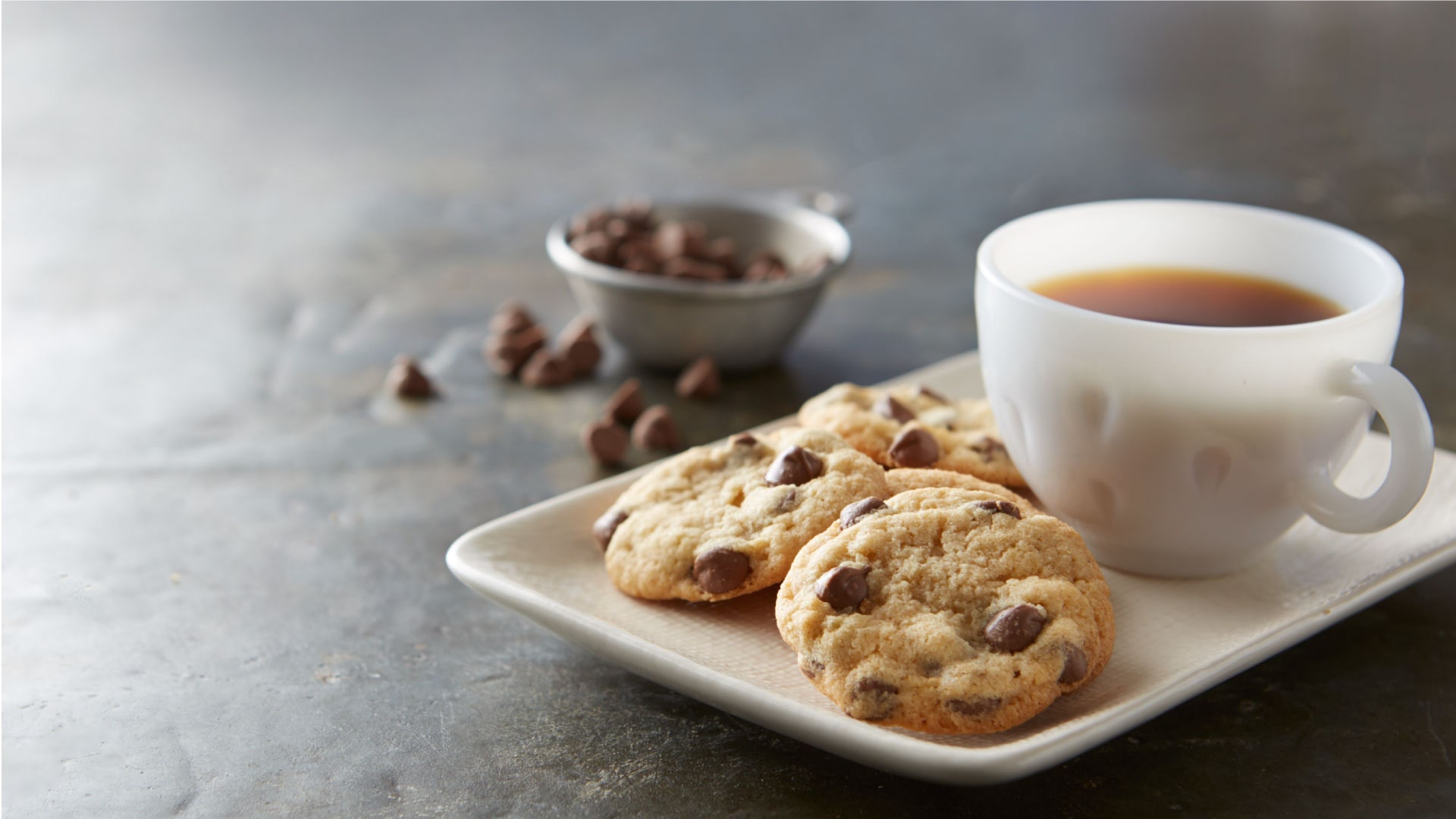 chocolate chip cookies next to a cup of tea