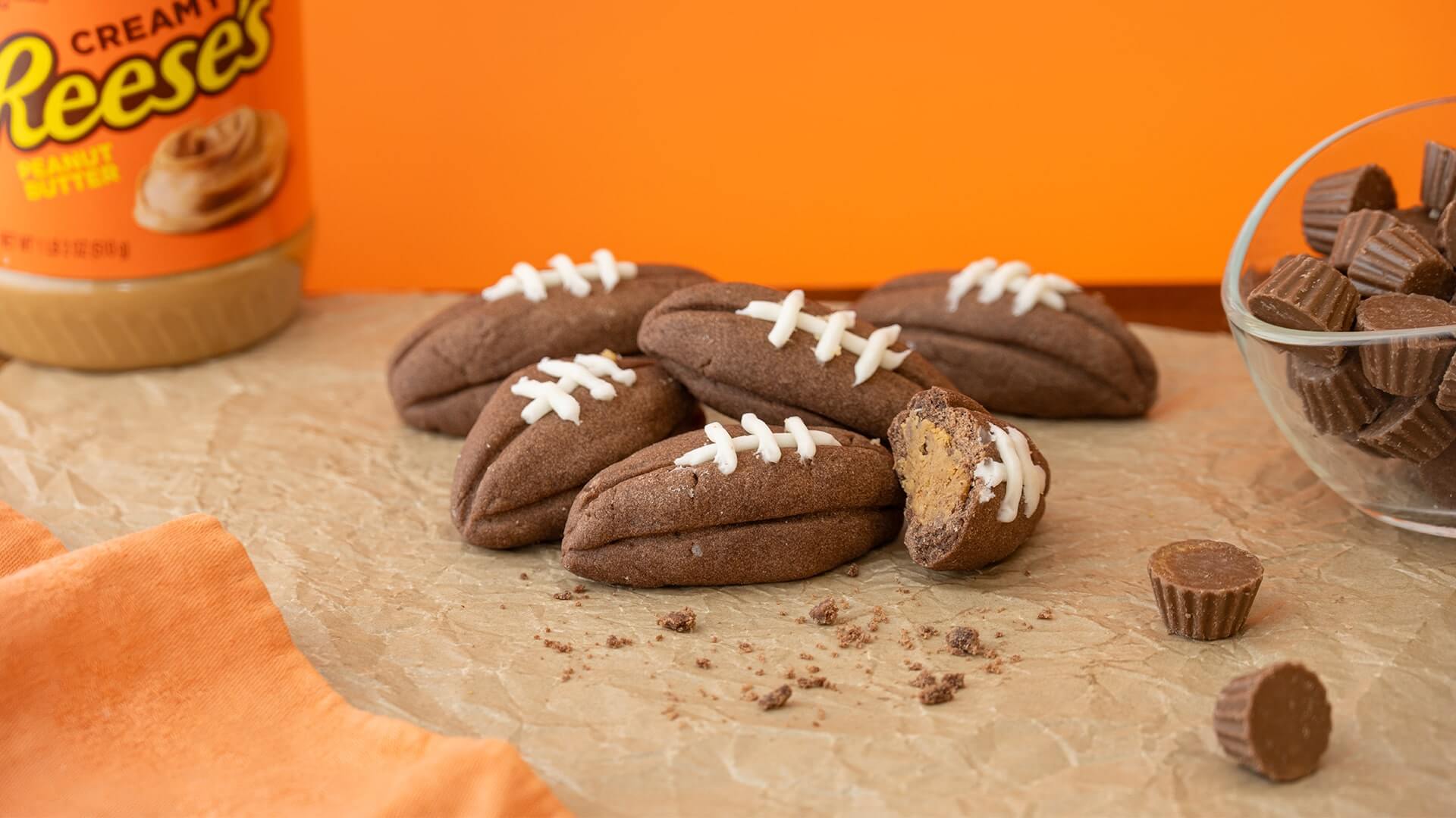 reeses stuffed football cookies on parchment paper