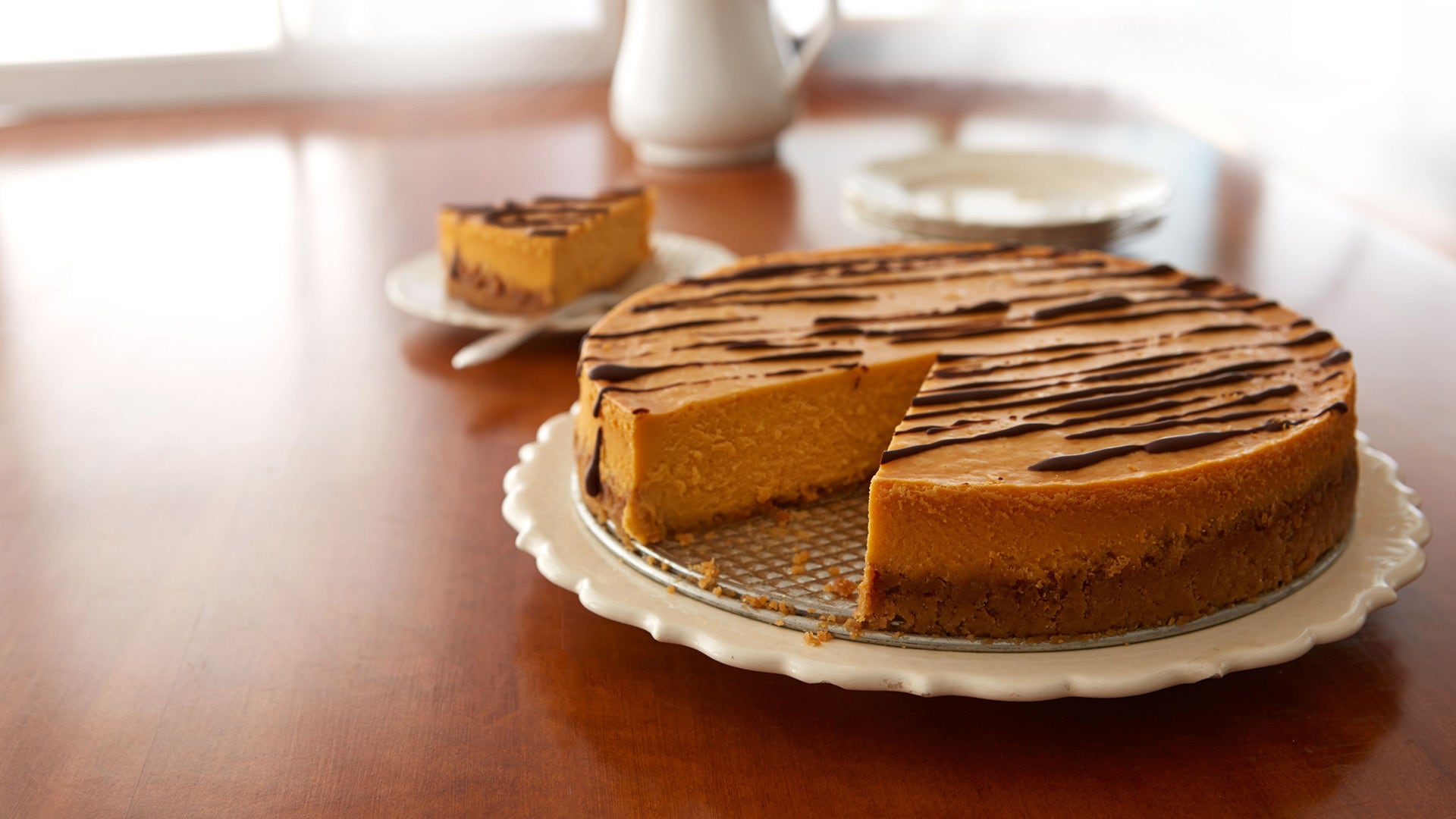pumpkin cinnamon cheesecake with chocolate drizzle