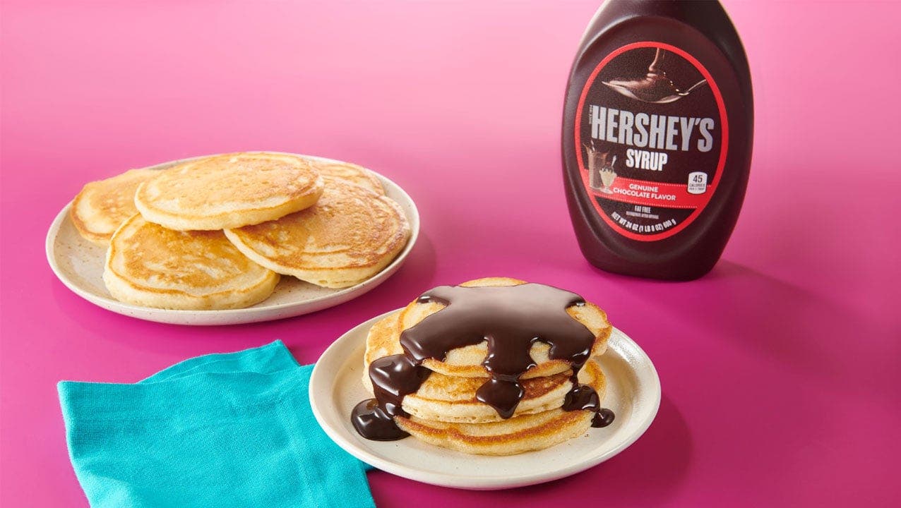 pancakes covered in Hershey's chocolate syrup