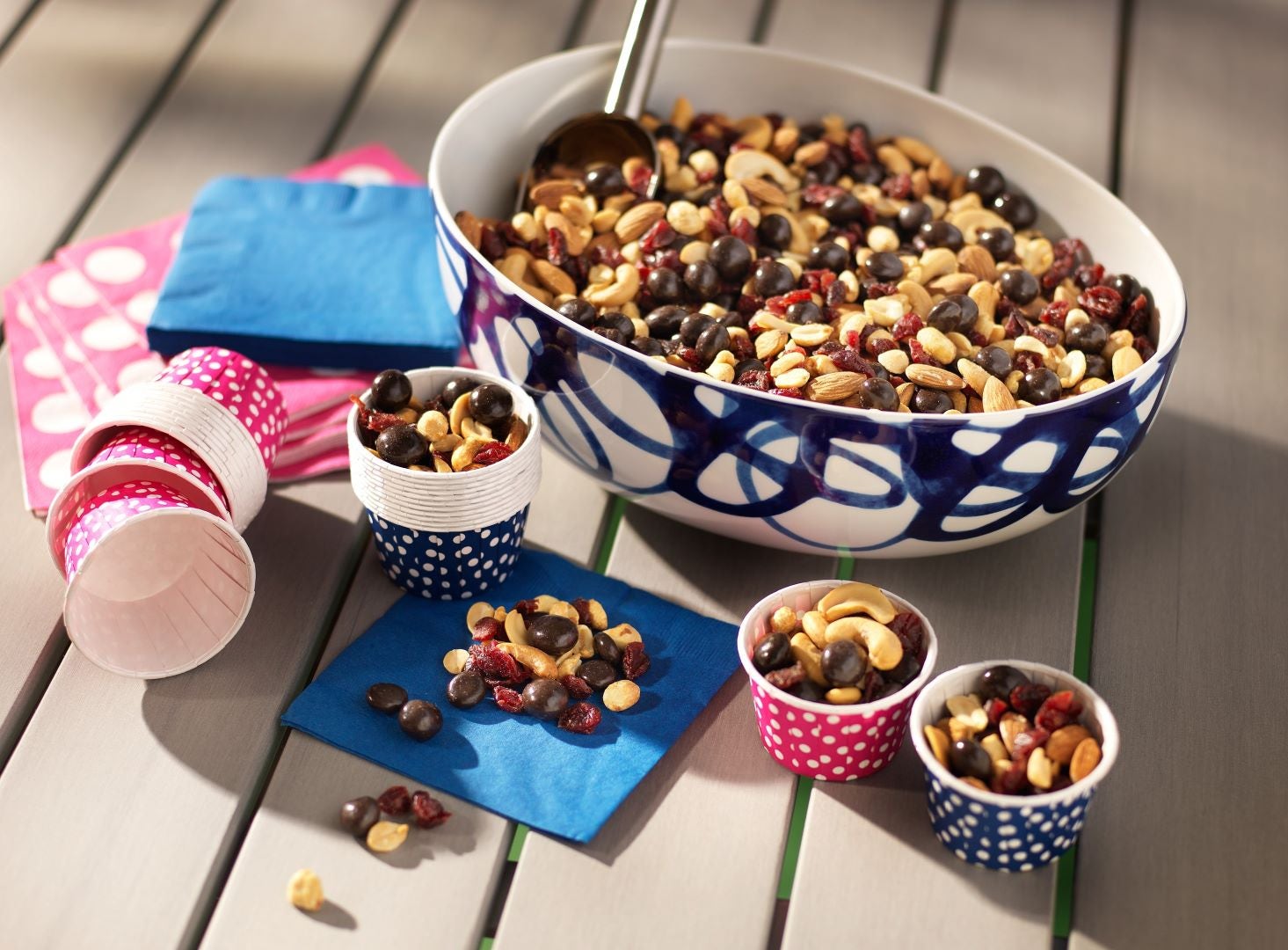 large bowl and a few small cups filled with trail mix