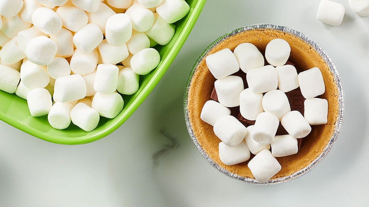 topping the mini pie shell with mini marshmallows