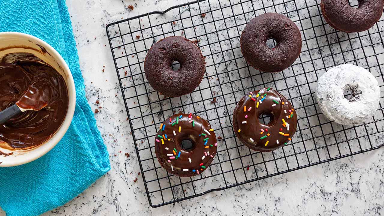 tray of freshly baked chocolate cake donuts with and without chocolate glaze